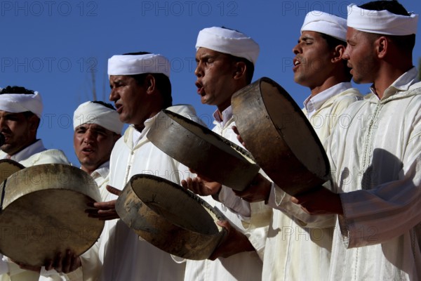 Men in white clothes play drums at the traditional Berber festival, Ma El Kelâa m'Gouna, Fête des Roses, Berber Dances
