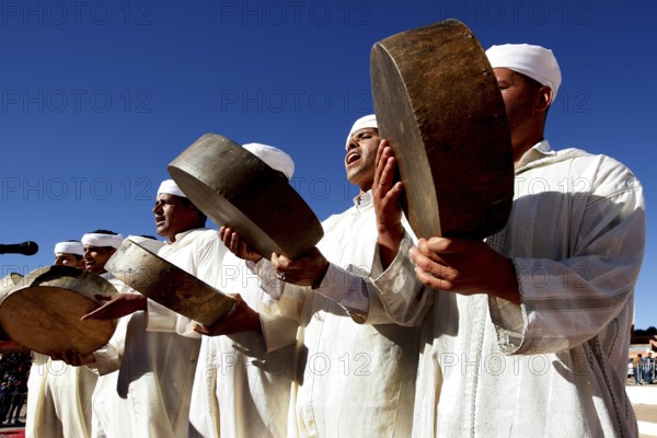 Men in traditional clothing play drums at the Fête des Roses, El Kelâa m'Gouna, Drâa-Tafilalet, Morocco