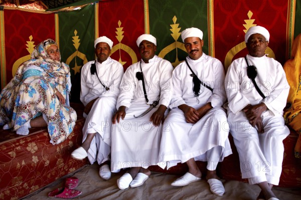 Participants wearing traditional Berber clothing during the Fête des Roses in the participant tent, El Kelâa m'Gouna, Drâa-Tafilalet, Morocco