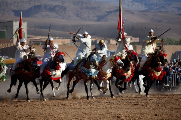 Committed riders cheer about the remarkable collaboration at the traditional Fantasia equestrian spectacle, El Kelâa m'Gouna, Morocco