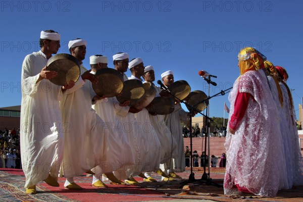 Berber dancers in traditional white clothes dance at the Festival of Roses, Ma El Kelâa m'Gouna, Fête des Roses, Berber Dances