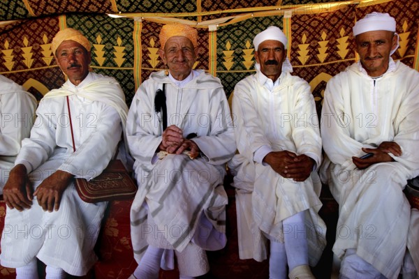 Four men wearing traditional clothes at the Fête des Roses in El Kelâa m'Gouna, El Kelâa M'gouna, Morocco