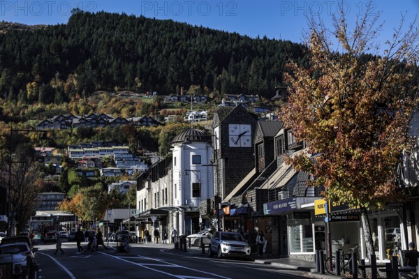 Bustling street in Queenstown lined with picturesque buildings and trees, Queenstown, New Zealand