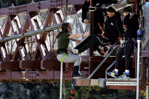 Female jumper preparing for a bungee jump from Kawarau Bridge, Queenstown, Otago, New Zealand