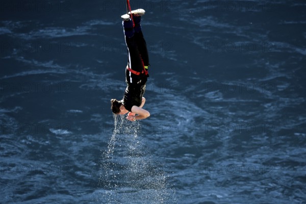 Jumpers diving headfirst into water from lofty heights, Queenstown, Otago, New Zealand