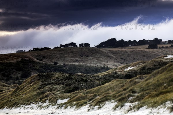 Wide dune landscape in Sandfly Bay with dramatic skies on the Otago Peninsula, Sandfly Bay, New Zealand
