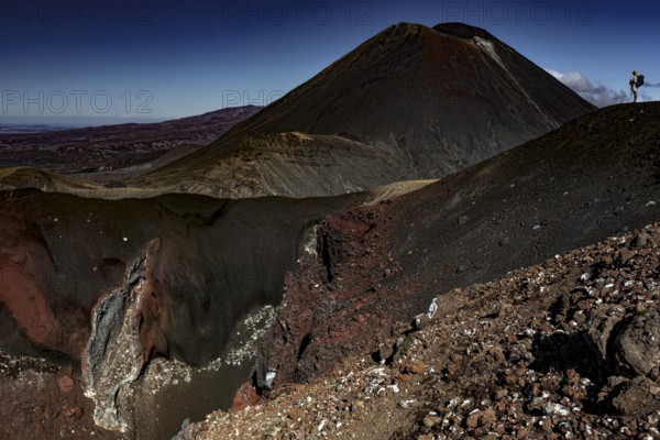 Majestic view of Mount Tongariro and Mount Ngauruhoe with boulders in the foreground, Tongariro National Park, Waikato, New Zealand