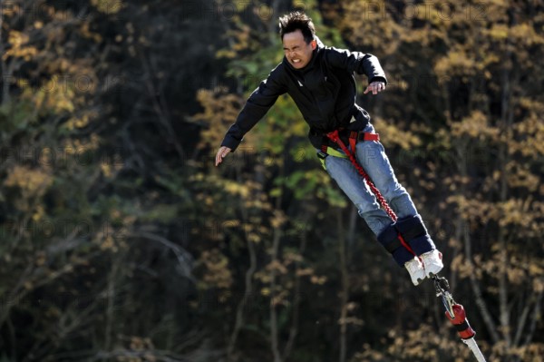 Free fall person bungee jumping in autumn, Queenstown, Otago, New Zealand