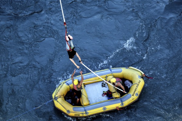 Bungee jumper is stopped over a yellow inflatable boat in the river, Queenstown, Otago, New Zealand