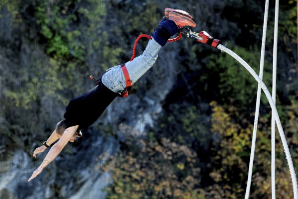 Person upside down in free fall from bungee jumping at Kawarau Bridge, Queenstown, Kawarau Bridge, New Zealand