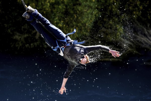 Jumpers bungee jumping touches the water of the Kawarau River, Queenstown, Kawarau Bridge, New Zealand