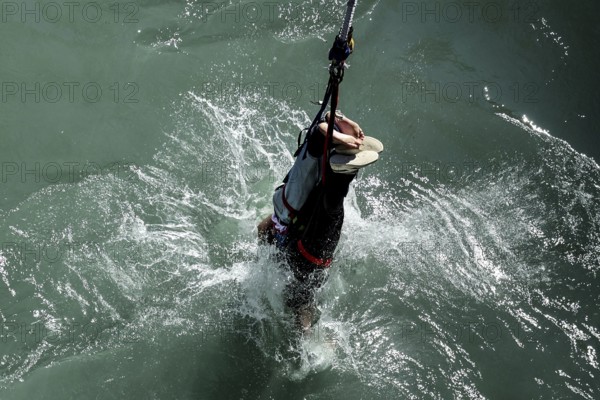 Bungee jumper dives into water near Kawarau Bridge, Queenstown, Otago, New Zealand