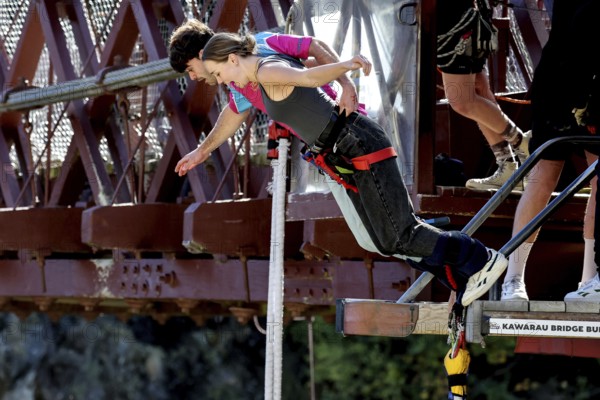 Person boldly jumps off Kawarau Bridge while bungee jumping, Queenstown, Otago, New Zealand