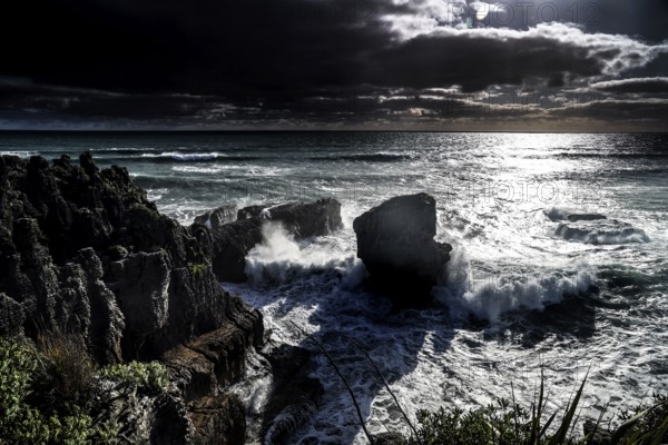 Moonlight over Pancake Rocks in Punakaiki, lined with powerful ocean waves, Punakaiki, West Coast, New Zealand