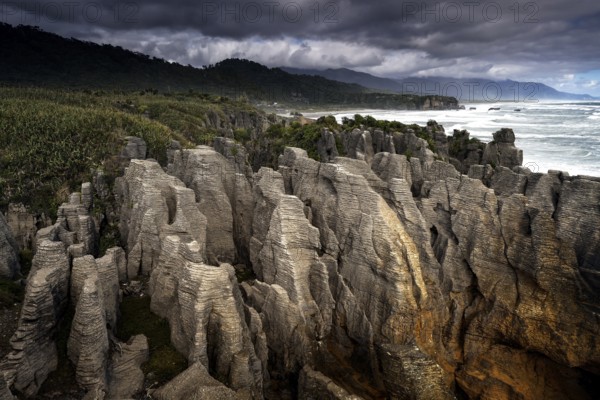 Pancake Rocks in stormy weather overlooking the ocean, Punakaiki, West Coast, New Zealand