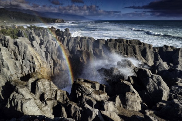 Water fountain rises at Pancake Rocks in Punakaiki, Punakaiki, West Coast, New Zealand