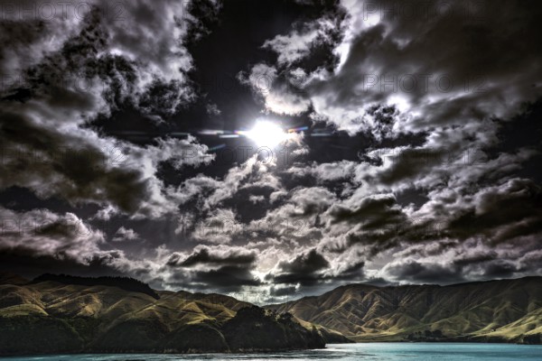 Moonlight breaks through dramatic clouds over Queen Charlotte Sound, Queen Charlotte Sound, Marlborough, New Zealand