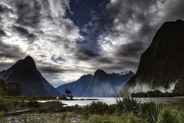 Impressive fjord with dramatic skies and majestic high mountains, Milford Sound, New Zealand