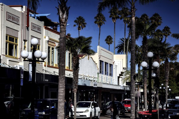 Street scene with art deco buildings and palm trees on a sunny day, Napier, Hawke's Bay, New Zealand