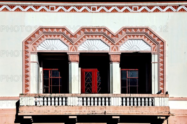 Close-up of an art deco balcony with geometric pattern and red doors, Napier, Hawke's Bay, New Zealand