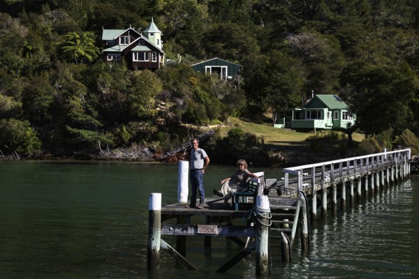 Timber house and pier on quiet Pelorus Sound, part of the mail delivery