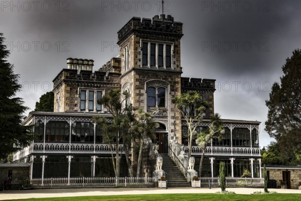 Neo-Gothic castle with stone façade on the Otago Peninsula under gloomy skies, Otago Peninsula, New Zealand