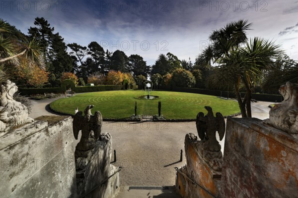 Round garden area in front of Larnach Castle, surrounded by trees and sculptures, Otago Peninsula, New Zealand