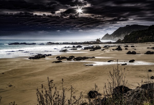 Beach at Nugget Point under a dramatically cloudy sky, Nugget Point, Otago, New Zealand