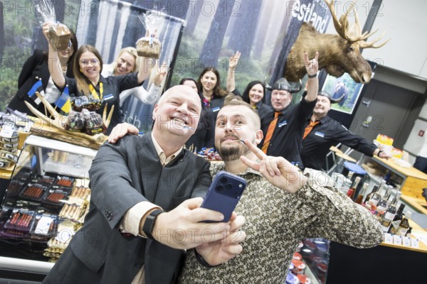 Two men take pictures of themselves at the Estonian stand at the Green Week at the exhibition center in Berlin on 16.01.2026. The Agricultural and Food Industry Fair will take place from January 16-25, 2026