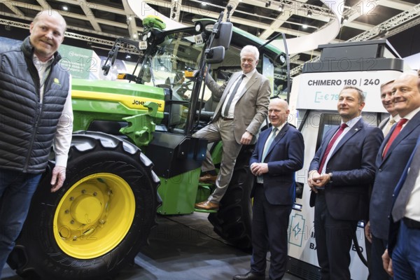 Alios Rainer (Federal Minister of Agriculture, Food and Home Affairs) and Kai Wegner (Governing Mayor of Berlin) in front of an electric John Deere E-Power prototype tractor during the opening tour of the Green Week at the exhibition grounds in Berlin on 16 January 2026. The trade fair for the agricultural and food industry will take place from 16 to 25 January 2026