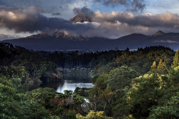 Lake Mangamahoe with Mount Taranaki in the background, surrounded by wooded landscape, New Zealand, zero