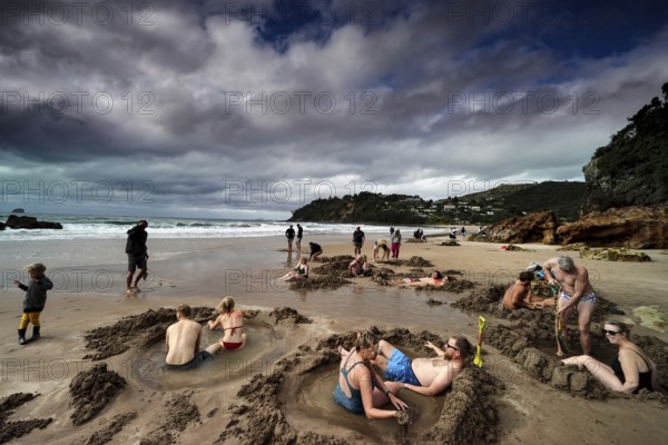 People enjoy Hot Water Beach, build sand castles and relax, Hot Water Beach, Coromandel Peninsula, New Zealand