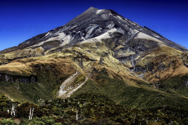 Impressive view of the summit of Mount Taranaki under clear blue skies in Mt Egmont National Park, Taranaki, New Zealand