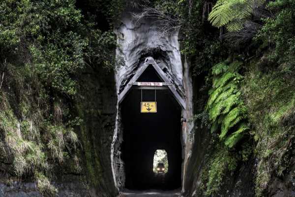 The Moki Tunnel along the Forgotten World Highway, New Zealand, surrounded by thick vegetation, zero
