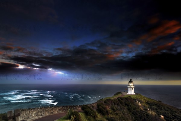 Confluence of Tasman Sea and Pacific at Cape Reinga with lighthouse and color sky, Cape Reinga, Northland, New Zealand