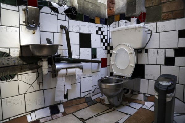 Creatively designed laundry room with mosaic tiles in a Hundertwasser toilet, Kawakawa, New Zealand