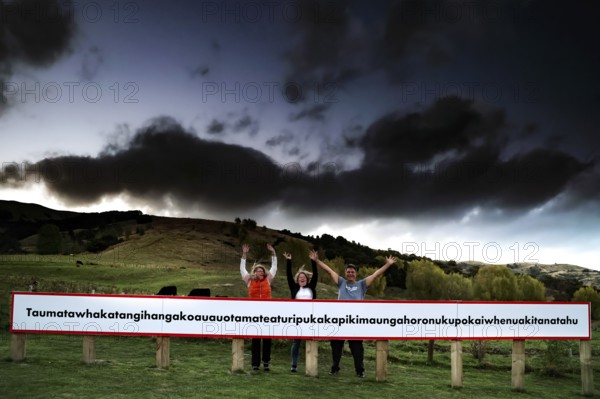 Long sign with the world's longest place name against a dramatic sky
