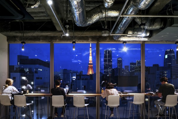 Nighttime view of Tokyo's illuminated skyline from a modern room, Tokyo, Japan