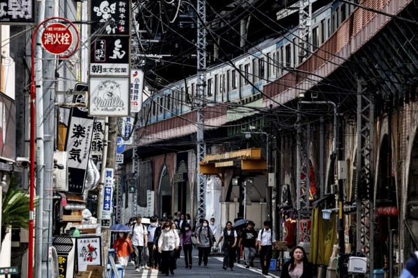 Bustling street scene in Chuo with numerous people and shops, Tokyo, Japan
