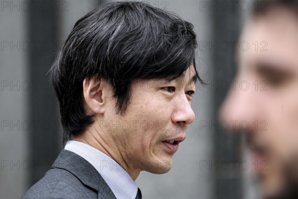 A businessman wearing a suit engrossed in Tokyo, Tokyo, Hamamatsucho, Japan