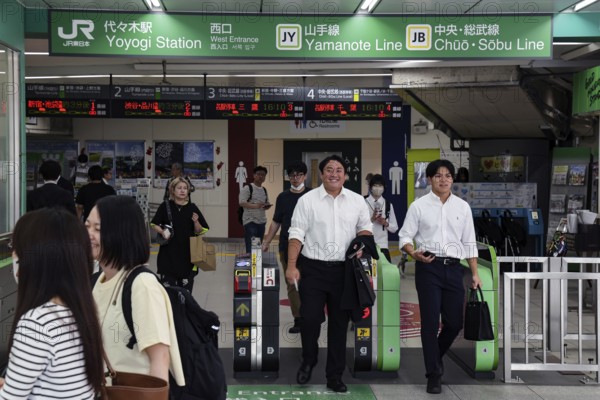 Entrance of a busy train station with commuters in Tokyo, Tokyo, Japan
