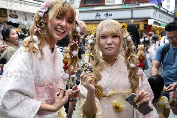 Two woman wearing white kimonos smile in Asakusa, Tokyo, Asakusa, Japan