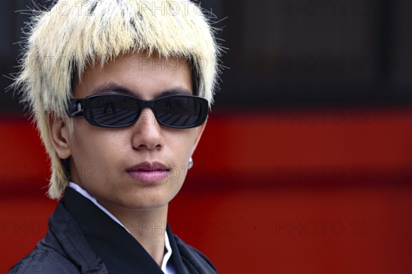 Young man with blonde hair and sunglasses in modern style, Tokyo, Asakusa, Japan