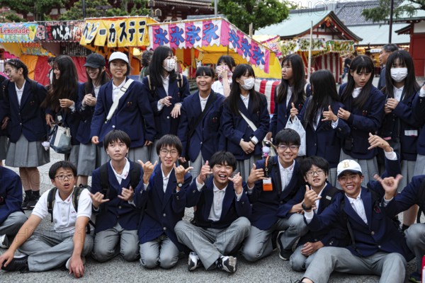 Group of students in uniform pose happily during a trip to Asakusa, Tokyo, Asakusa, Japan