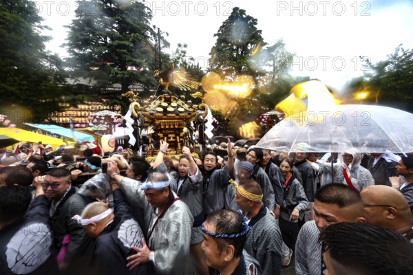 Crowd of people with umbrellas at festive Sanja Matsuri parade, Tokyo, Asakusa, Japan