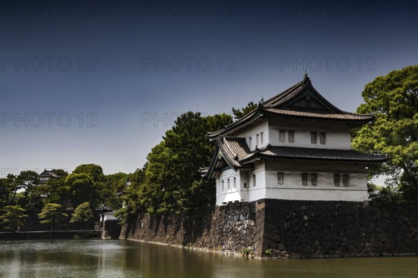 Imperial Palace wall with adjacent moat in peaceful surroundings, Tokyo, Japan
