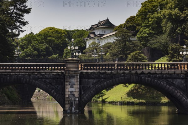 The Nijubashi Bridge in front of the Imperial Palace surrounded by lush greenery, Tokyo, Japan