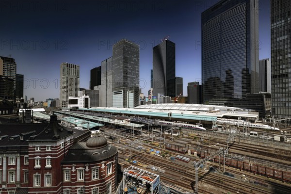 View of Tokyo Station from a roof garden with modern buildings, Tokyo, Japan