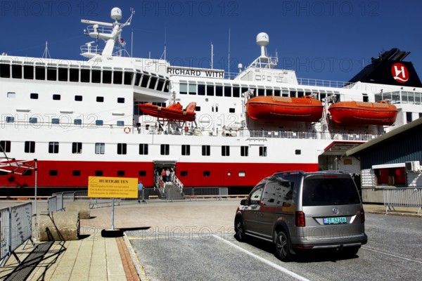 Car parked in front of a Hurtigruten ship in the port of Kirkenes, Kirkenes, Finnmark, Norway