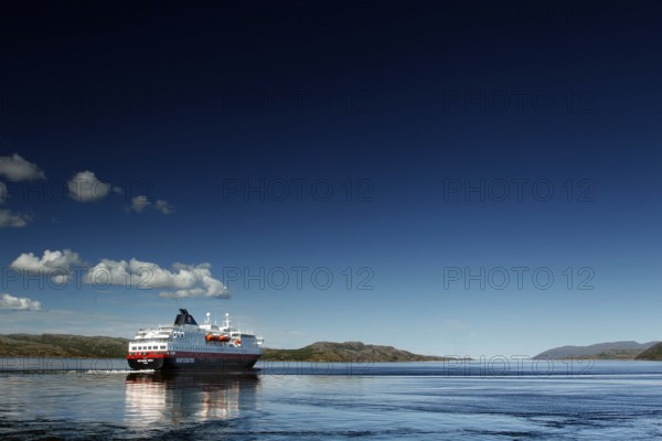 Hurtigruten ship on calm sea with bright sky, Kirkenes, Finnmark, Norway